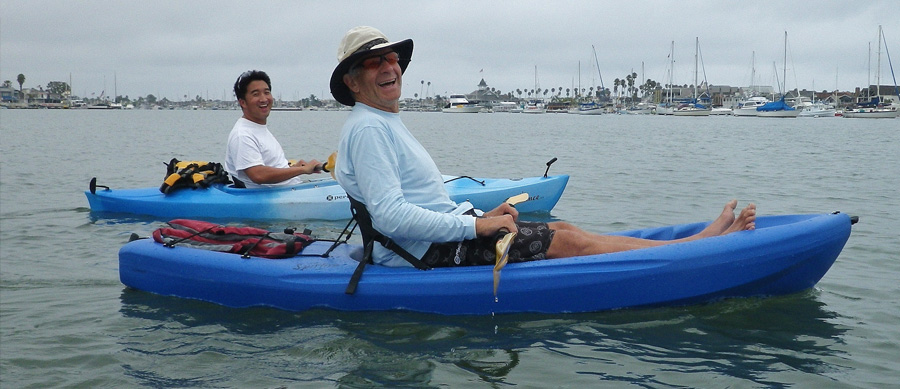 Two Men Happily Kayaking